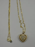 Heart pendant necklace combines romantic filigree detailing with brilliant moissanite accents for an elegant, eye-catching style.