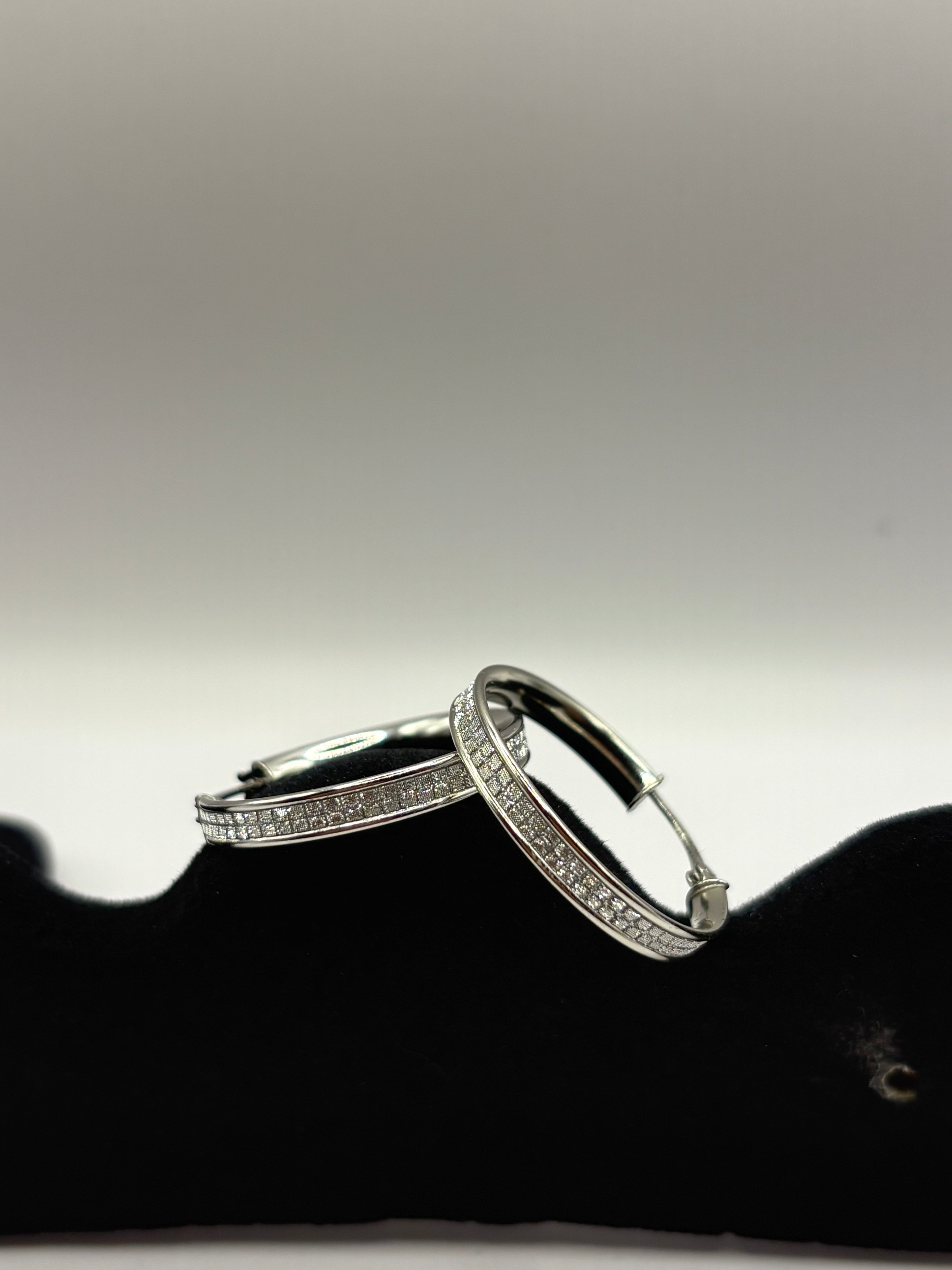 These classic hoop earrings feature a refined dual-row pave channel setting
