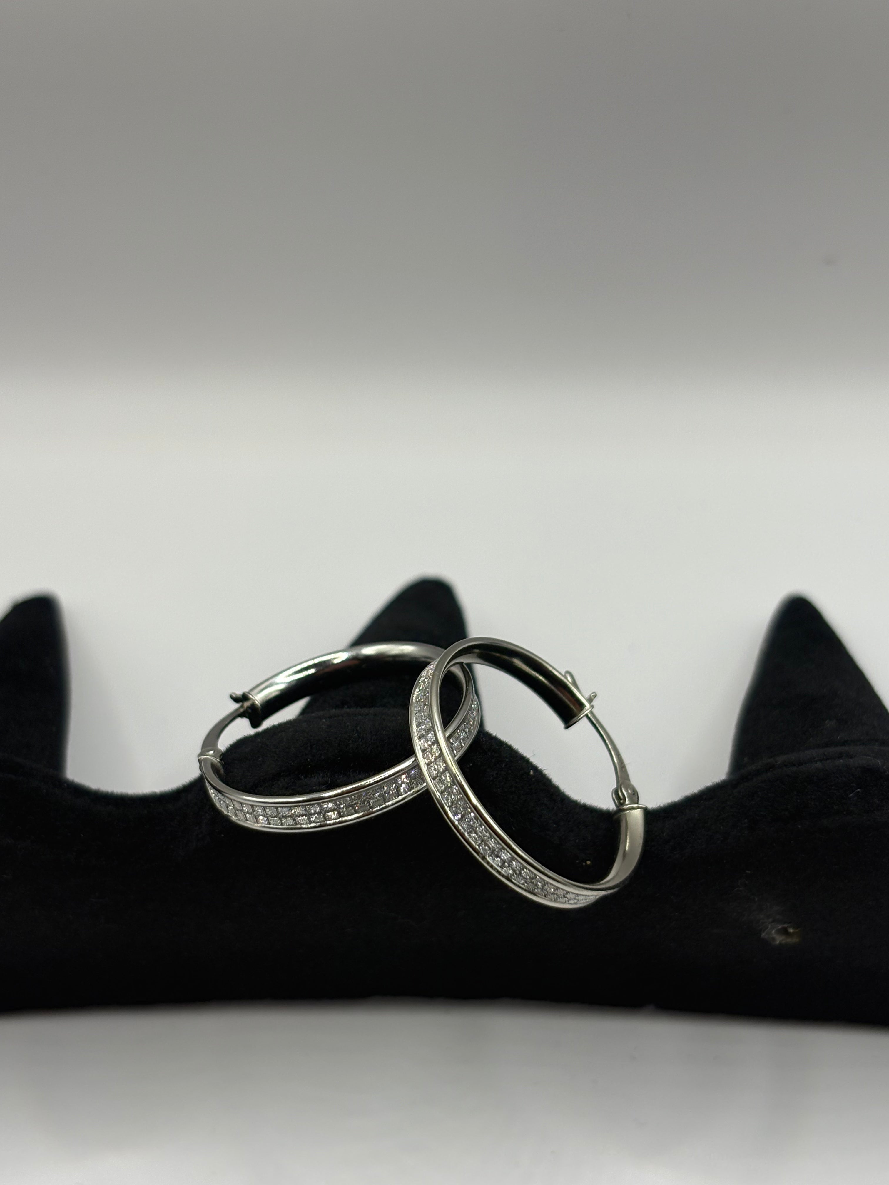 These classic hoop earrings feature a refined dual-row pave channel setting