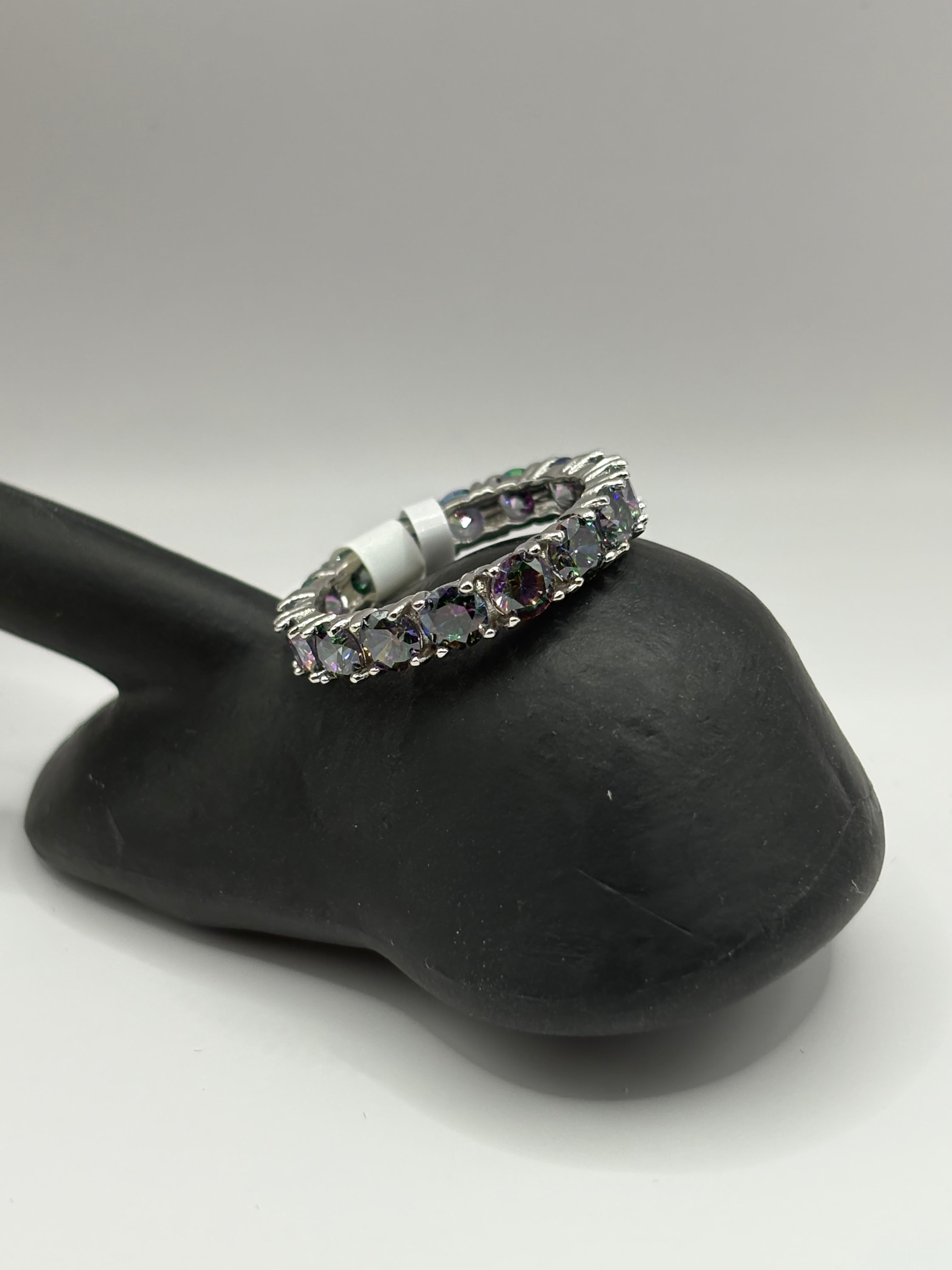 Mystic Topaz Eternity Ring combines continuous brilliant-cut gemstones with a sleek, polished finish