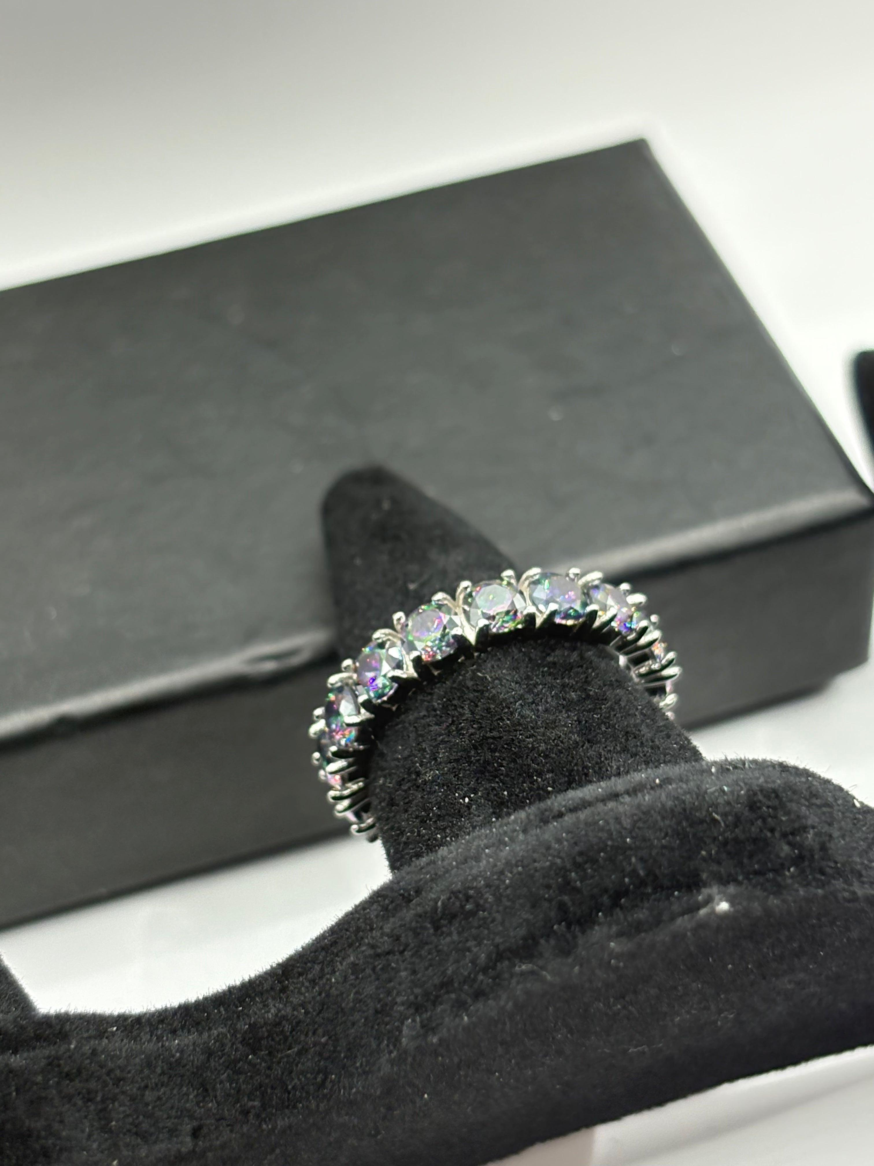 Mystic Topaz Eternity Ring combines continuous brilliant-cut gemstones with a sleek, polished finish